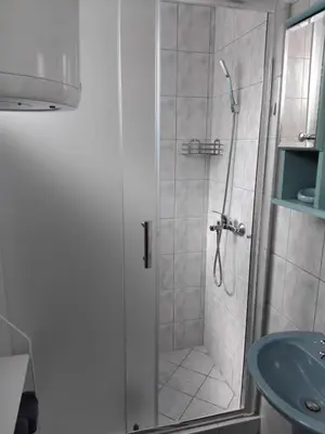 a bathroom with a shower and a sink at Apartman Breskvica in Bihać
