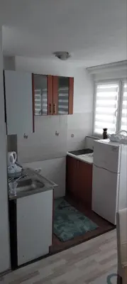 a kitchen with a sink and a counter top at Apartman Breskvica in Bihać