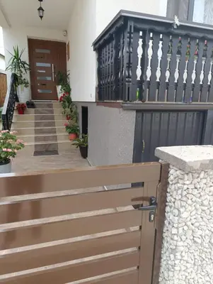 a wooden gate in front of a house with stairs at Gajanka in Bugojno