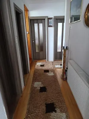 a hallway with a rug on the floor and two doors at Gajanka in Bugojno