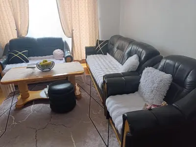 a living room with two leather couches and a table at Gajanka in Bugojno