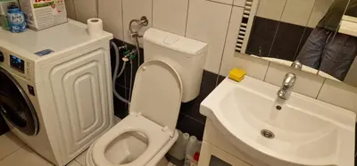 a bathroom with a white toilet and a sink at Apartment Plava Voda in Travnik