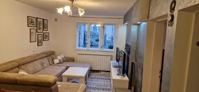 a living room with a couch and a tv at Apartment Plava Voda in Travnik