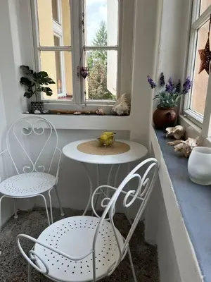 a room with two chairs and a table and a window at Cozy&Arty House with Garden&Parking- in the centre in Banja Luka