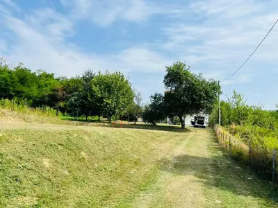 a field of grass with a fence and trees at Vikendica Bregovi in Doboj