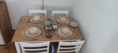 a wooden table with plates and dishes on it at Vikendica Bregovi in Doboj