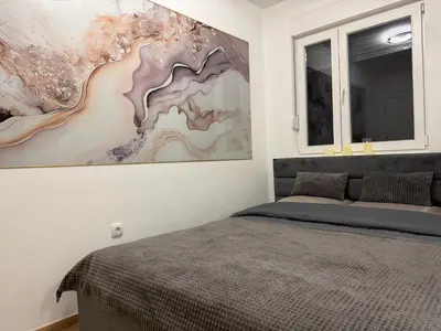 a bedroom with a bed and a painting on the wall at Apartman So Chic kod Kastela in Banja Luka