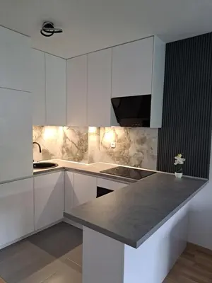a kitchen with white cabinets and a gray counter top at Apartman So Chic kod Kastela in Banja Luka