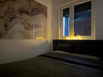 a bedroom with a bed and a window with lights at Apartman So Chic kod Kastela in Banja Luka