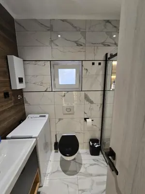 a bathroom with a toilet and a sink at Suite M in Livno