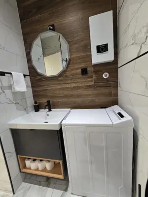 a bathroom with a white sink and a mirror at Suite M in Livno
