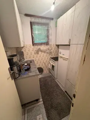 a small kitchen with a sink and a stove at Secret garden in Visoko