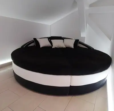 a black and white bed in a room at Mansarda Apartman Diva in Prijedor