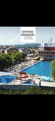 a view of a large swimming pool with people in it at Mansarda Apartman Diva in Prijedor