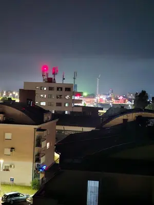 a view of a city at night with buildings at Mansarda Apartman Diva in Prijedor