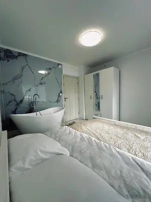 a bathroom with a white tub and a sink at Apartment Casa Deluxe in Visoko