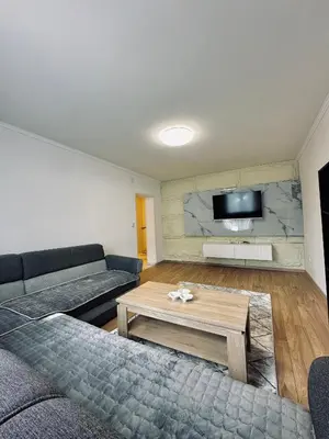a living room with a couch and a coffee table at Apartment Casa Deluxe in Visoko