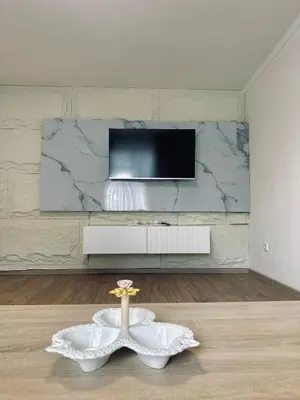 a living room with a tv and a table at Apartment Casa Deluxe in Visoko