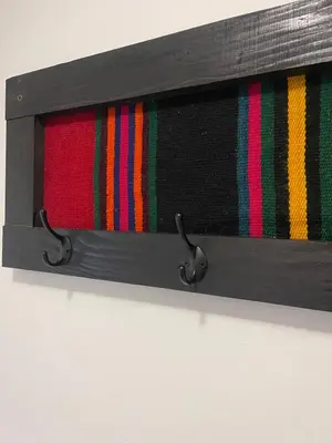 a wooden box with colorful ties on a wall at Sašina kuća in Livno
