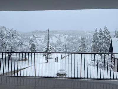 a balcony with a view of a snow covered yard at Sašina kuća in Livno