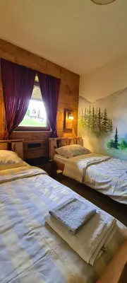 a bedroom with two beds and a window at Planinska kuća 