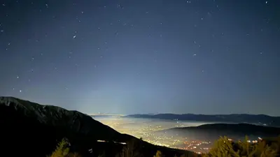 a view of a city at night from a mountain at Planinska kuća 