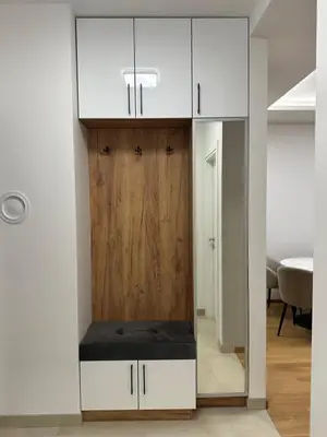 a room with a closet with a wooden door at GRAĐUS Deluxe Apartmani in Kotor-Varoš