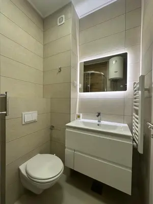 a bathroom with a toilet and a sink at GRAĐUS Deluxe Apartmani in Kotor-Varoš