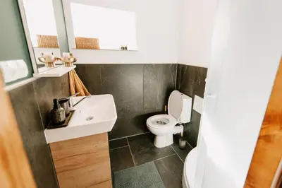 a bathroom with a sink and a toilet at Kuća s osmijehom in Livno