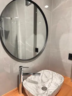 a bathroom with a sink and a mirror at Hotel Fortuna in Gradačac