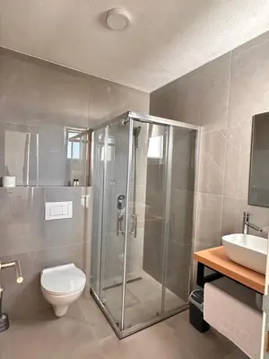 a bathroom with a shower and a toilet and a sink at Hotel Fortuna in Gradačac