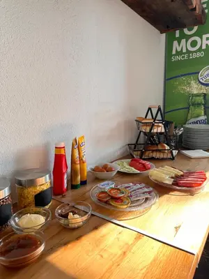 a table topped with different types of food at Hotel Fortuna in Gradačac