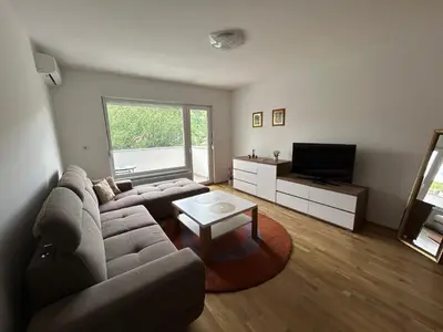 a living room with a couch and a tv at Apartment ALINA in Visoko