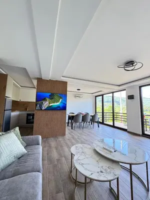 a living room with two tables and a couch at Villa Emilija Krupa na Vrbasu