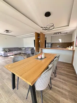 a kitchen and dining room with a wooden table and chairs at Villa Emilija Krupa na Vrbasu