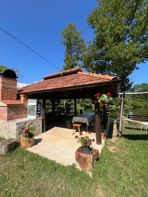 a gazebo with a picnic table in a yard at Villa Emilija Krupa na Vrbasu