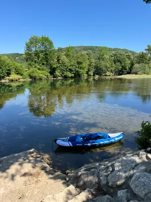 a blue kayak sitting in the water on a river at Villa Emilija Krupa na Vrbasu