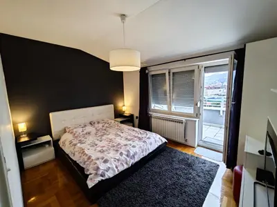 a bedroom with a bed and a large window at Sunny River BL in Banja Luka