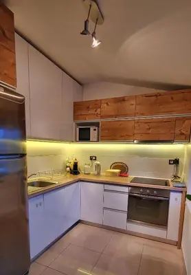 a kitchen with white appliances and wooden cabinets at Sunny River BL in Banja Luka