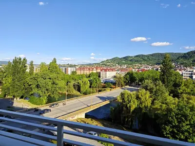 a view of a city with a bridge and a river at Sunny River BL in Banja Luka