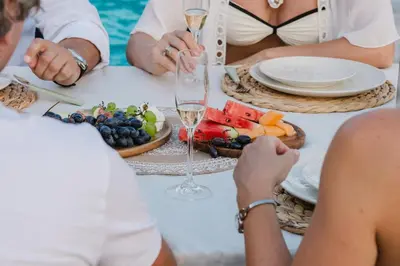 a group of people sitting around a table with wine glasses at Villa Alma Nova in Laktaši