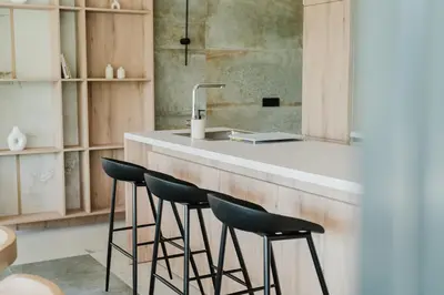 a kitchen with a counter with stools and a sink at Villa Alma Nova in Laktaši
