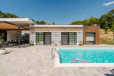 a swimming pool in front of a house at Villa Alma Nova in Laktaši