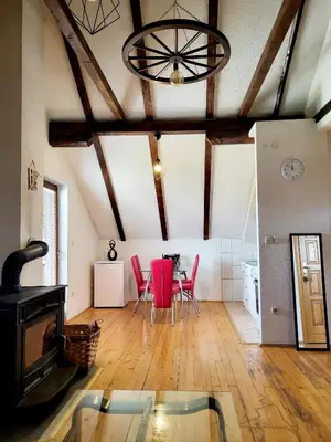 a living room with a table and red chairs at N&M Mountain Escape in Kupres