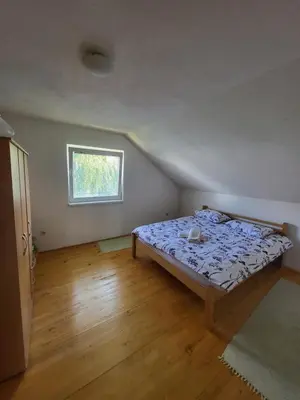 a bedroom with a bed in a room with a window at N&M Mountain Escape in Kupres