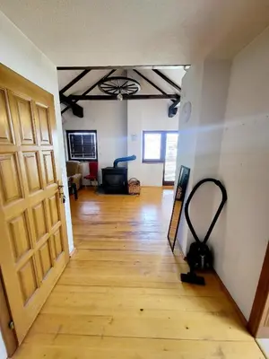 an empty room with a wooden floor and a door at N&M Mountain Escape in Kupres