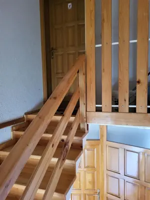 a wooden staircase leading up to a wooden door at N&M Mountain Escape in Kupres