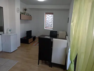 a room with a table and chairs and a window at Vlašić Vacation apartment in Vlasic