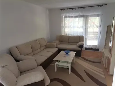 a living room with a couch and a table at Kuća na dan in Bosansko Grahovo