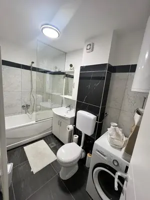 a bathroom with a toilet and a sink and a shower at Apartman Sara in Teslić